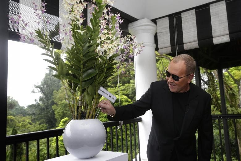 Fashion designer Kors with the Dendrobium Michael Kors at the National Orchid Garden. He plans to grow the namesake orchid at his new home in Florida.