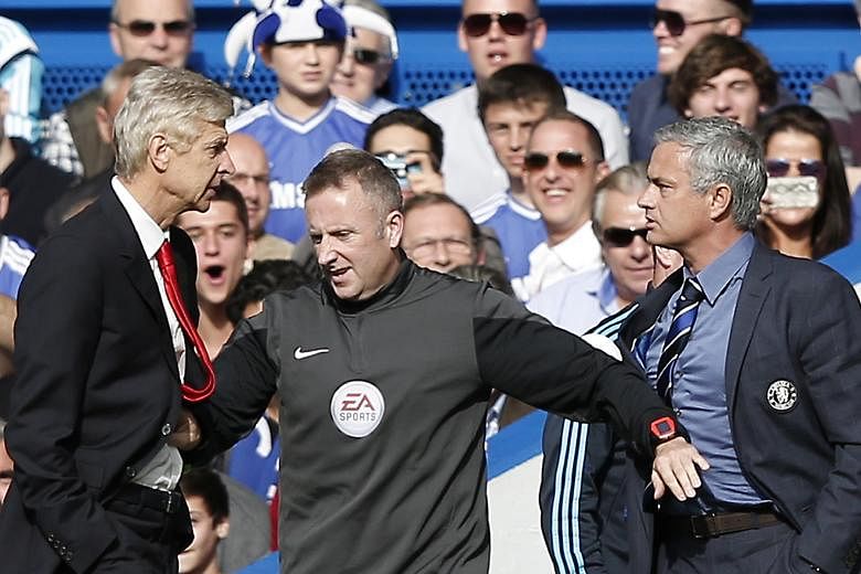 Jose Mourinho (right) and Arsene Wenger being kept apart by the fourth official Jonathan Moss during a Premier League match between Chelsea and Arsenal at Stamford Bridge two years ago.
