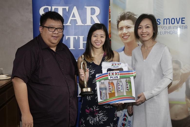 Bernice Lim (middle), the ST Star of the Month for October, with ST's assistant sports editor Chia Han Keong and Jennifer See, the general manager of F&N Foods Singapore.