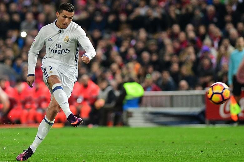 Cristiano Ronaldo opening accounts for Real with this free kick. His second-half penalty and tap-in took his derby tally to 18 goals and stretched the team's lead over second-placed Barcelona to four points.