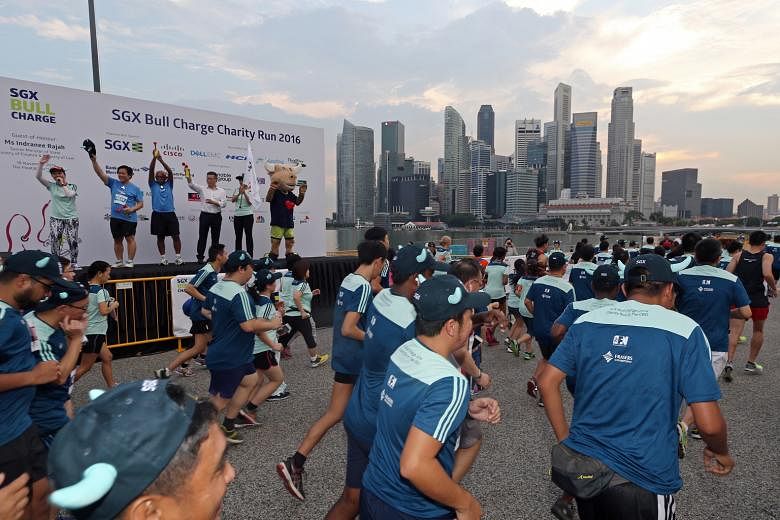 Participants setting off at the start of the 5km mass run of the 2016 SGX Bull Charge Charity Run last Friday. Bull Charge, the Singapore Exchange's flagship charity programme, has raised more than $2.6 million this year. Its grand finale - the annua