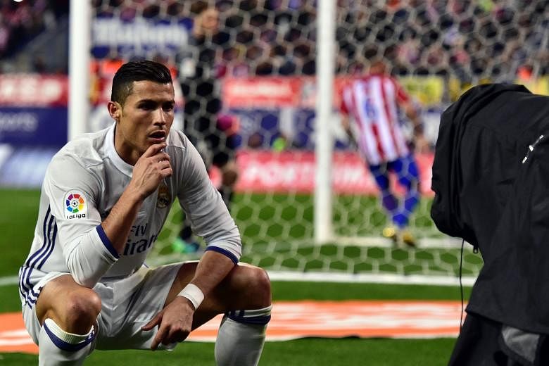 Portuguese forward Cristiano Ronaldo hamming it up for the TV cameras after his penalty gave Real Madrid a 2-0 lead against Atletico on Saturday. His hat-trick brought his derby tally to 18 goals.