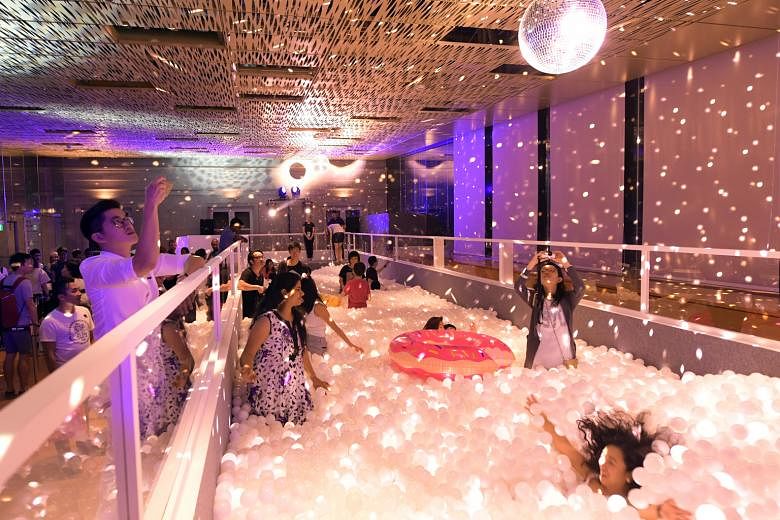 The Disco Ball Pit at the Glass Room was a hit at the launch of the National Gallery's Gallery Light To Night Festival yesterday. Up to 30 visitors at a time can dive into a tank containing more than 175,000 balls. The festival, which is also a celeb