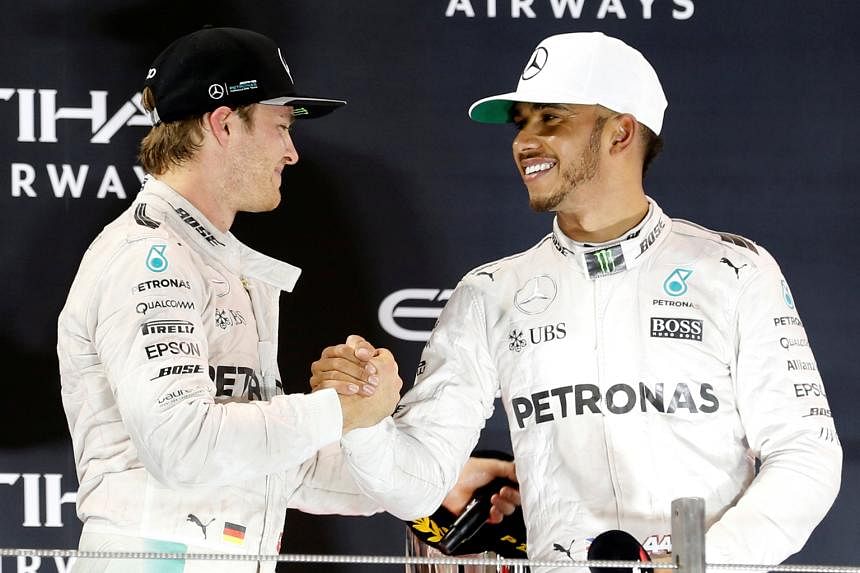 Nico Rosberg (left) shakes hands with team-mate Lewis Hamilton after a tense finish to the race. The Briton was repeatedly ordered to speed up by Mercedes but replied: "Let us race."