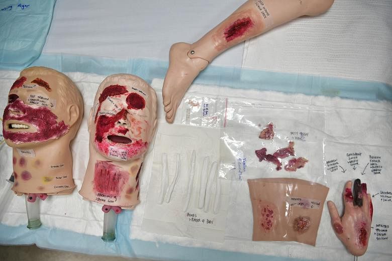 Clockwise, from top left: Fake wounds created by instructors for students during a course at NUS on Nov 15. Nanyang Polytechnic School of Health Sciences (Nursing) lecturer Huang Fang learning how to use make-up to create a scab during the course. So