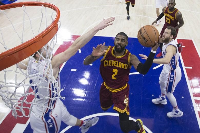 Cleveland Cavaliers' Kyrie Irving evading the attention of Philadelphia 76ers guard Nik Stauskas in making a play for a basket. The Cavs point guard's "hot hand" in the fourth quarter meant he took on his team's scoring responsibility in the game's l