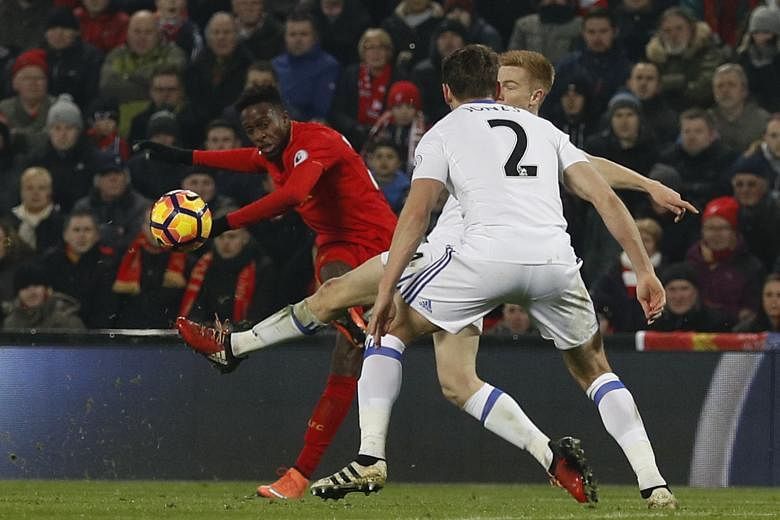 Liverpool striker Divock Origi whipping a shot past Sunderland's Duncan Watmore and Billy Jones (No. 2) for the Reds' opener in their 2-0 win. The Belgian will be looking to pick up the scoring mantle again with a number of players likely to be reste