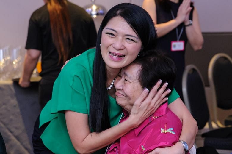 Ms Kelly Ling, 50, a Cathay Pacific in-flight service manager and learning and development executive, was overjoyed to be reunited with her former teacher Violet Tan at the event. (From left, standing) Former OPS pupils Peggy Wee, 49, now an accounta