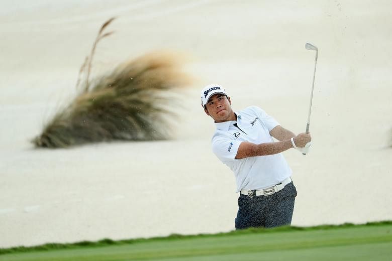 Japan golfer Hideki Matsuyama hits a shot from a greenside bunker en route to his two-shot victory at the Hero World Challenge, his fourth title in the past two months.