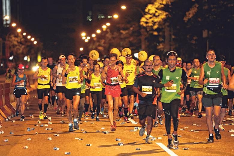 Marathon and half-marathon participants running along Marina Boulevard. Both the 42.195km and 21.1km events were were flagged off at 4.30am on Sunday, with runners finishing at the Padang.
