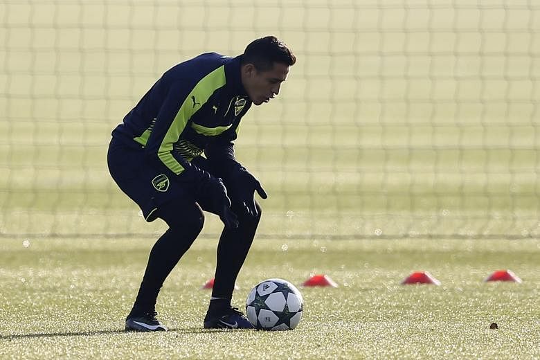 Arsenal's Alexis Sanchez, who scored a hat-trick in their 5-1 rout of West Ham on Saturday, trains for their final Champions League group-stage match against FC Basel.