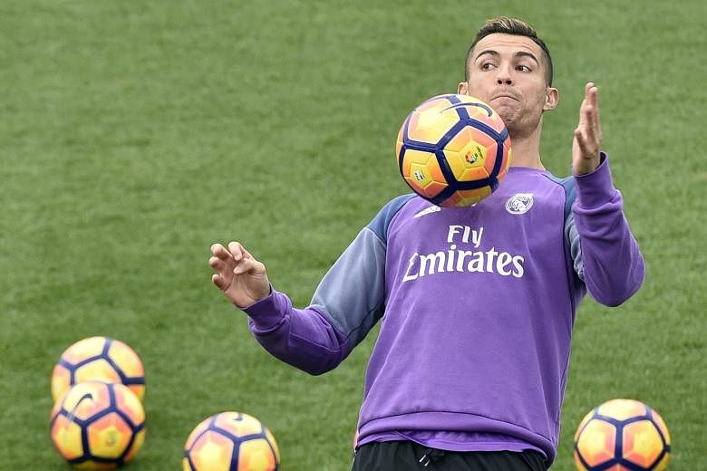 Cristiano Ronaldo showing off his ball control during training the day after he revealed his income. The Spanish leaders meet Deportivo tomorrow before flying to Japan where they aim to win a second Club World Cup in three years.