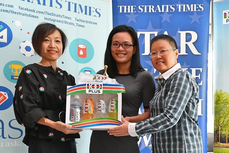 Tiffany Teo (centre) receives her ST Star of the Month award from from Jennifer See (left), general manager of F&N Foods Singapore, and ST's sports editor Lee Yulin.