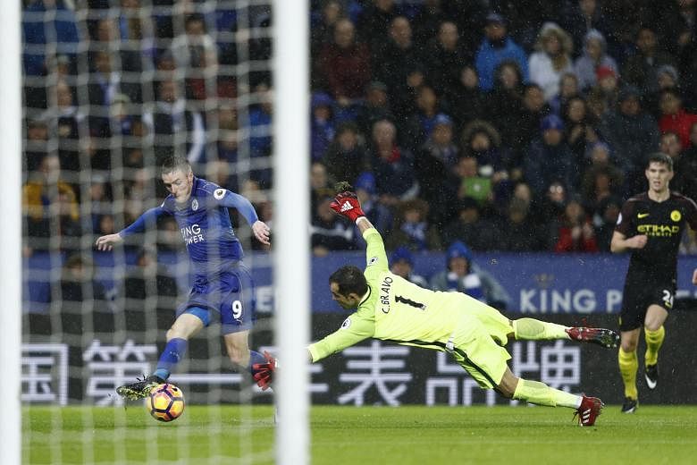 Leicester City's Jamie Vardy rounding Manchester City goalkeeper Claudio Bravo before scoring his third goal of the match. The Foxes won the Premier League clash 4-2.