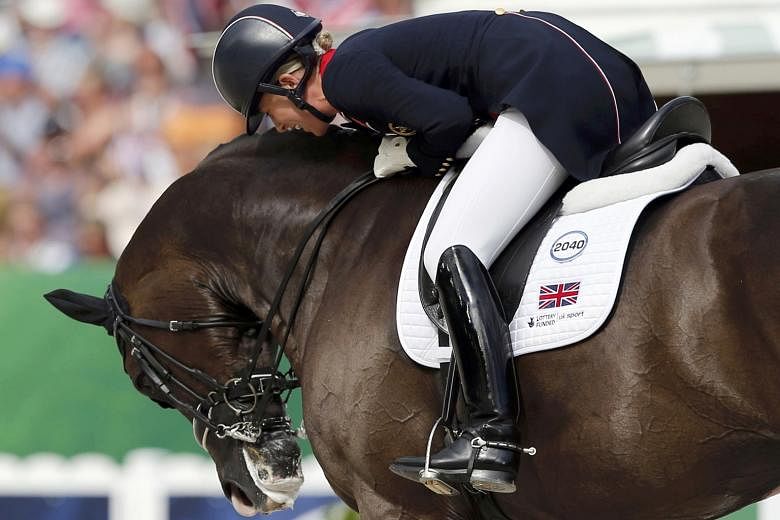 Britain's Charlotte Dujardin celebrates with her horse Valegro in 2014. While the gelding is to retire, Dujardin has said she will be photographed in her wedding dress on the horse before she walks down the aisle next year.