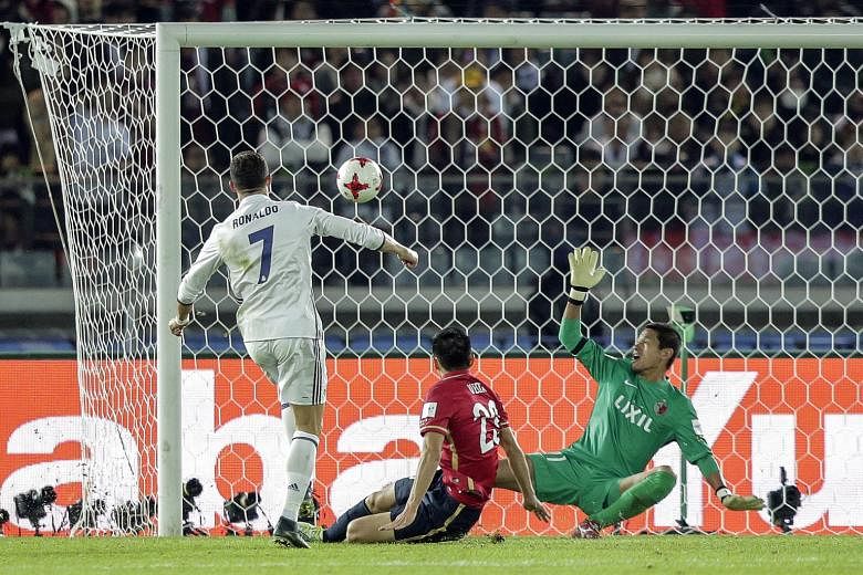 Real Madrid's Cristiano Ronaldo scoring the fourth goal against Kashima Antlers to complete his hat-trick and the 4-2 extra-time victory in the Club World Cup final yesterday. The Portuguese is also the joint-top scorer in the competition's history w