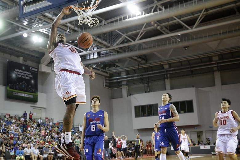 Singapore Slingers' Xavier Alexander dunking two of his 25 points in his team's 71-68 win over the Alab Pilipinas at the OCBC Arena yesterday. It was the Slingers' fourth win in five games.