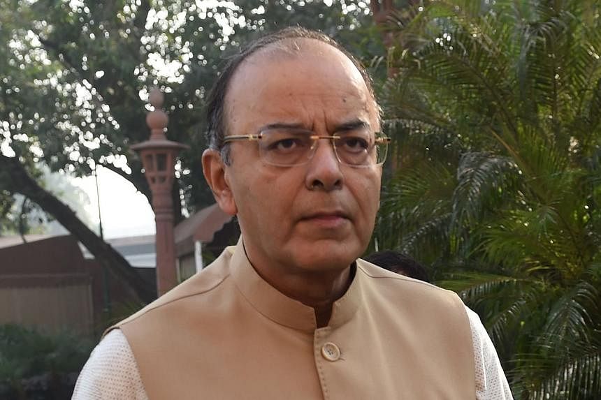 Mr Modi (top) said people in financial markets must make a "fair contribution" to nation building, but Mr Jaitley (above) clarified that the government did not plan to impose long- term capital gains tax.