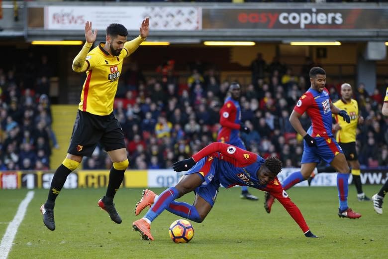 Crystal Palace's Wilfried Zaha going down following contact with Miguel Britos in the penalty area, earning himself a caution. And it was certainly no laughing matter for the Englishman after the league match, when the Watford mascot mimicked the inc