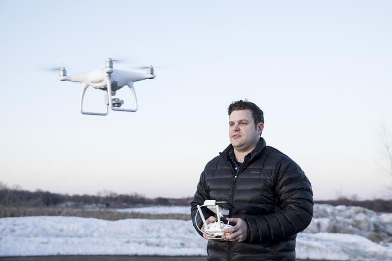 Mr Kyle Christy flying his DJI Phantom 4 drone in Minnesota. Airplanes do not allow on board some electronic devices with more powerful lithium-ion batteries such as drones.