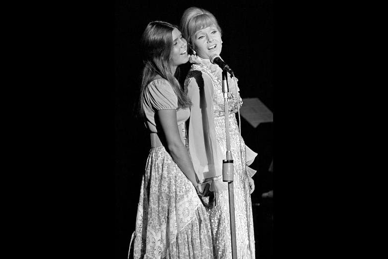 Debbie Reynolds with her daughter Carrie Fisher on Reynolds' opening night at the Desert Inn in Las Vegas in 1971. Debbie Reynolds with Carrie Fisher (far left) at the 21th Annual Screen Actors Guild Awards ceremony in Los Angeles in 2015 and with El