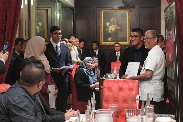 National silat exponent Iqbal Abdul Rahman receiving a certificate of appreciation from Minister for the Environment and Water Resources Masagos Zulkifli at last night's appreciation dinner hosted by the Singapore Silat Federation. The 23-year-old wo