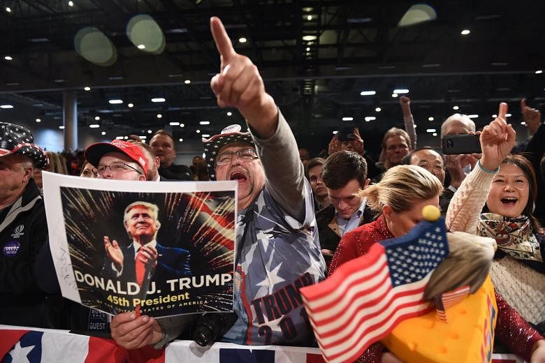 Supporters in Des Moines, Iowa, cheering during US President-elect Donald Trump's "Thank-You" tour last month. To rural Americans, it seems their taxes mostly go to making city residents live better. They also think the liberal worldview creates unne