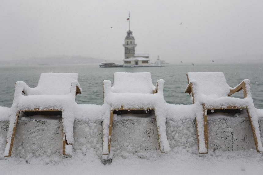 Snow-covered chairs along the Bosporus in Turkey on Sunday. The strait is closed to ships due to the severe weather.