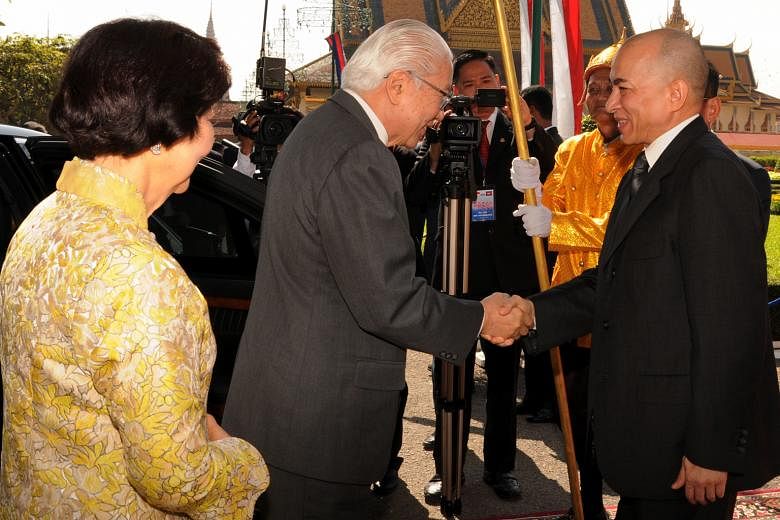 President Tony Tan Keng Yam and his wife on arrival at the Royal Palace where they are greeted by King Norodom Sihamoni. Dr Tan, who is on a four-day state visit, will go to Siem Reap today.