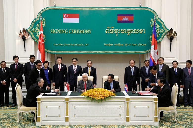 President Tony Tan Keng Yam sitting next to Cambodian Prime Minister Hun Sen at the signing of two agreements yesterday that will see cooperation in vocational training for infocommunications technology, electronics and automotive technology, as well