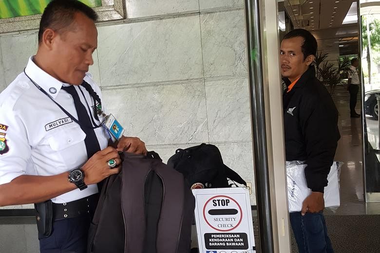 Security guard Mulyadi checks every bag at the mall and screens everyone, including staff.