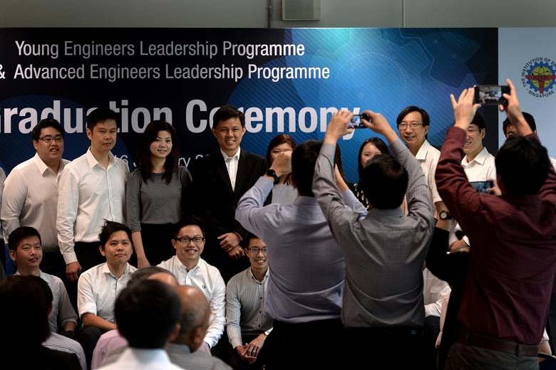 Minister Chan Chun Sing (centre, in black) with the engineers who had undergone training programmes organised by NTUC and the Institution of Engineers, Singapore. The programmes are part of an industrywide career development plan to help engineers mo