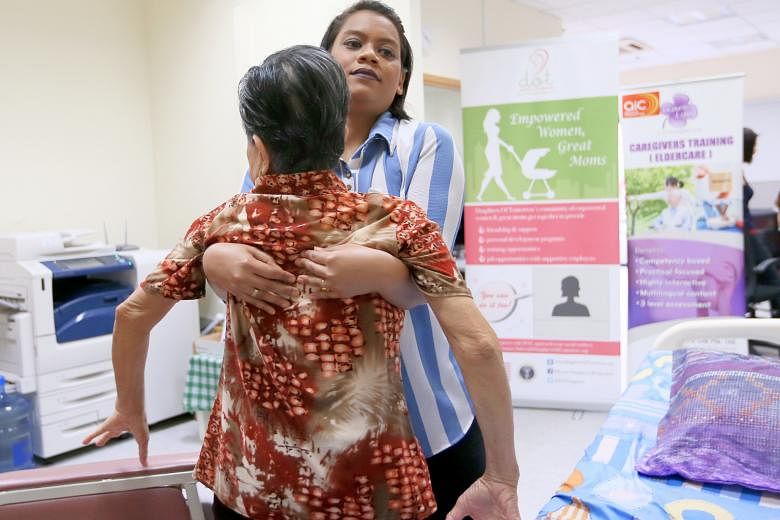 Madam Nur Fadzelah Sapullah demonstrates some of the skills she learnt when she joined the eldercare training programme last November. For example, one lesson was how to properly carry an elderly patient so that both patient and caregiver are safe.
