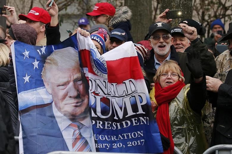 Trump supporters lining the parade route at the inaugural parade in Washington on Friday. Mr Trump's desire to build new highways and airports appealed to one expat here, as did his promise to improve schools and help those on welfare.