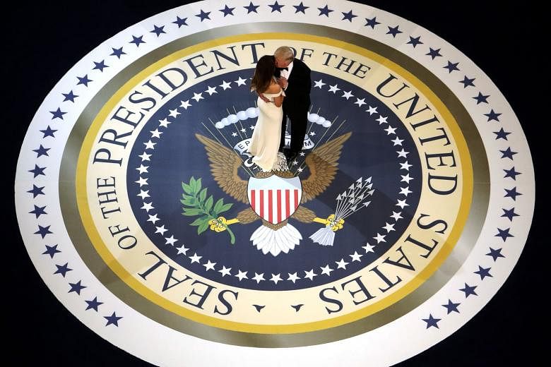 President Donald Trump and his wife Melania dancing on stage during A Salute To Our Armed Services Inaugural Ball at the National Building Museum in Washington, DC on Friday, when Mr Trump was sworn in as the 45th President of the United States.
