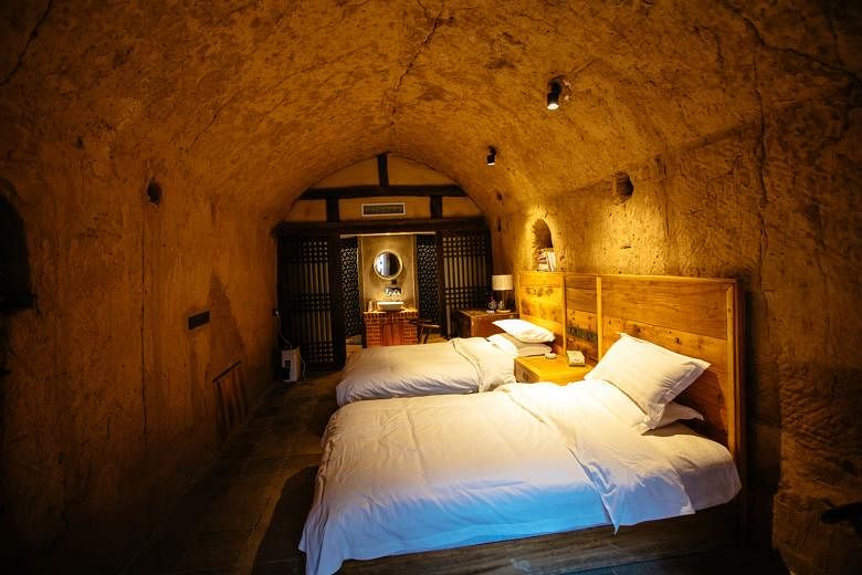 The interior and exterior of an old cave dwelling that has been converted into a boutique hotel in Mengzhou, in China's Henan province. Cave dwellings were an ancient way of life in the mountainous region. With more than 180 cave dwellings still rema