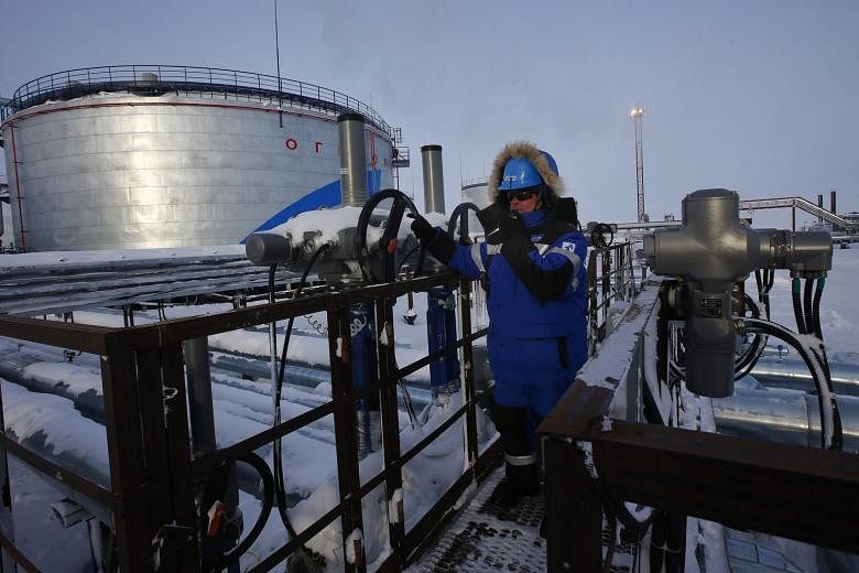 An employee of Russian gas and oil giant Gazprom working in an oilfield in northern Russia. Global oil prices rose to an 18-month high of more than US$58 a barrel after Opec and several non-members agreed to cut output last month. Crude oil has since