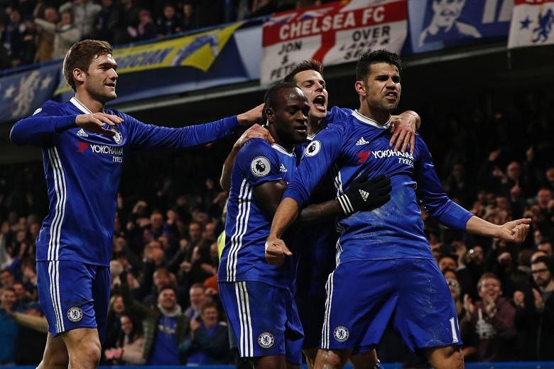 Chelsea striker Diego Costa (right) being mobbed by team-mates after scoring the opening goal in their 2-0 Premier League win against Hull.