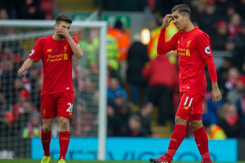 Liverpool's Adam Lallana (left) and Roberto Firmino face an uphill task to get the Reds back in the title hunt.