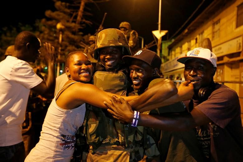 Former president Mr Jammeh, who ruled for 22 years, finally ceded power and left Gambia on Saturday. Residents of the Gambian capital of Banjul celebrating the arrival of West African forces on Sunday. The Economic Community of West African States de