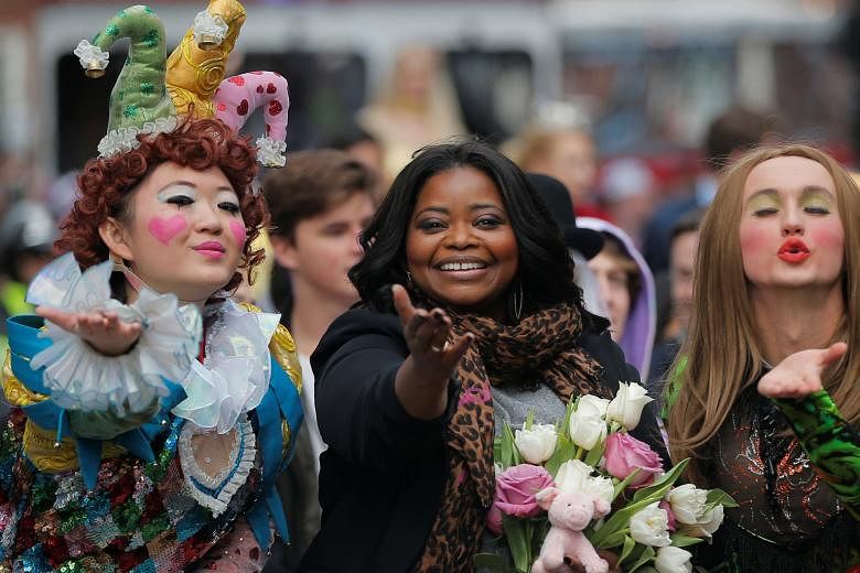 Actress Octavia Spencer (centre, with Hasty Pudding Theatricals president Guan-Yue Chen, left, and cast vice-president Dan Milashewski) at a parade on Thursday to honour her as Hasty Pudding Theatricals' Woman of the Year at Harvard University in Mas