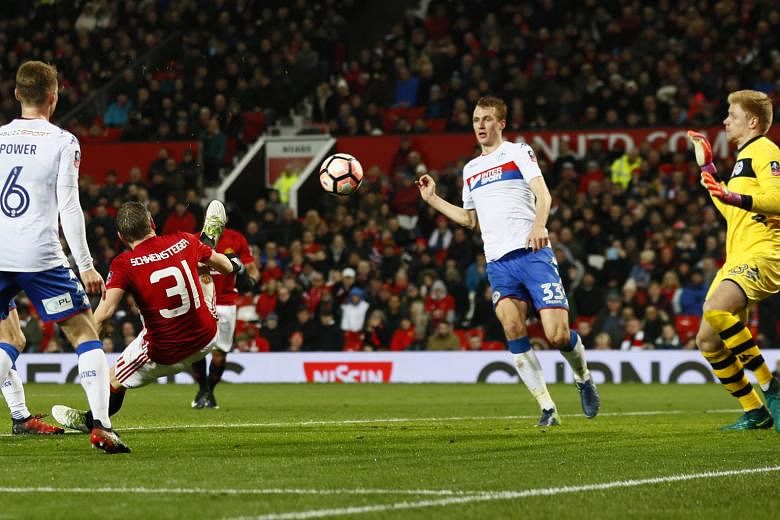Bastian Schweinsteiger scoring Manchester United's fourth goal against Wigan in the fourth round of the FA Cup. United ran out comfortable 4-0 winners at home and remain in the hunt for four trophies - the Premier League, the League Cup, the FA Cup a