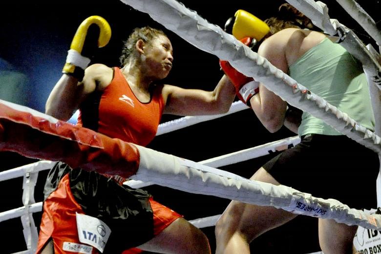 Laishram Sarita Devi pins Zsofia Bedo against the ropes on Sunday. Devi, who was making her professional debut, won the contest by a unanimous decision at the Khuman Lampak Stadium in Imphal, India.