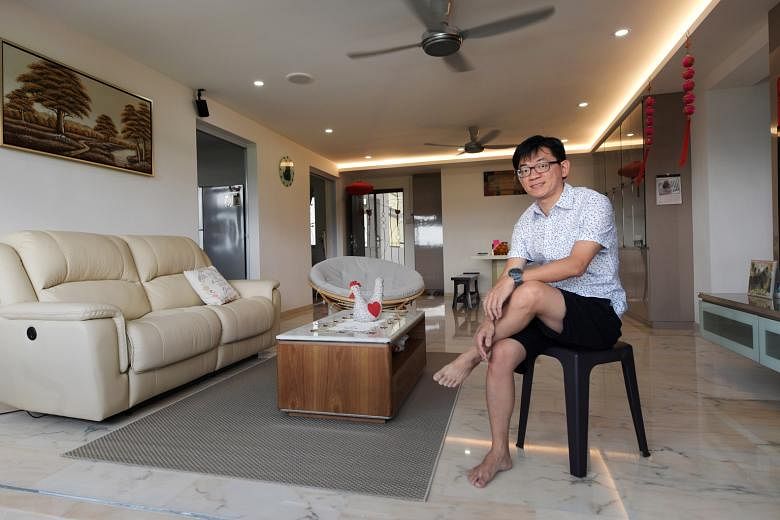 Mr Che at his HDB executive apartment in Bukit Batok. The first time he stepped into the living room, he was taken by its spaciousness. Spanning 1,600 sq ft, the apartment has four bedrooms. Tucked away amid an expanse of greenery, it is, nevertheles