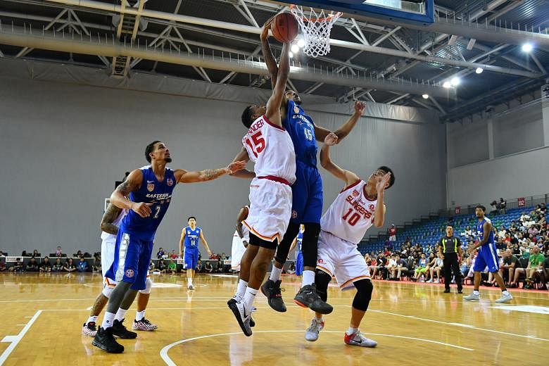 Hong Kong Eastern Long Lions' Patrick Sullivan trying to score while being blocked by Singapore Slingers' Alexander Xavier Allen at the OCBC Arena yesterday. The Asean Basketball League table-topping Slingers slumped to a shock loss yesterday at the 