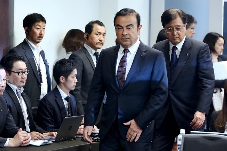 Nissan chief executive Carlos Ghosn (centre) with Mitsubishi chief Osamu Masuko behind him at a news conference last year. Nissanbought the controlling stake in Mitsubishi for 237 billion yen (S$3.2 billion) last October.