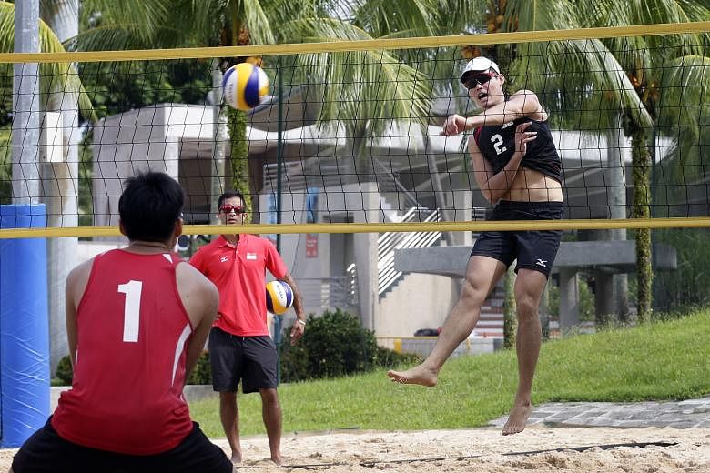 Dean Martin looks on as national beach volleyball player Mark Shen, 20, spikes during training on Sunday. The confidence expressed by the Canadian is already starting to rub off on his players.
