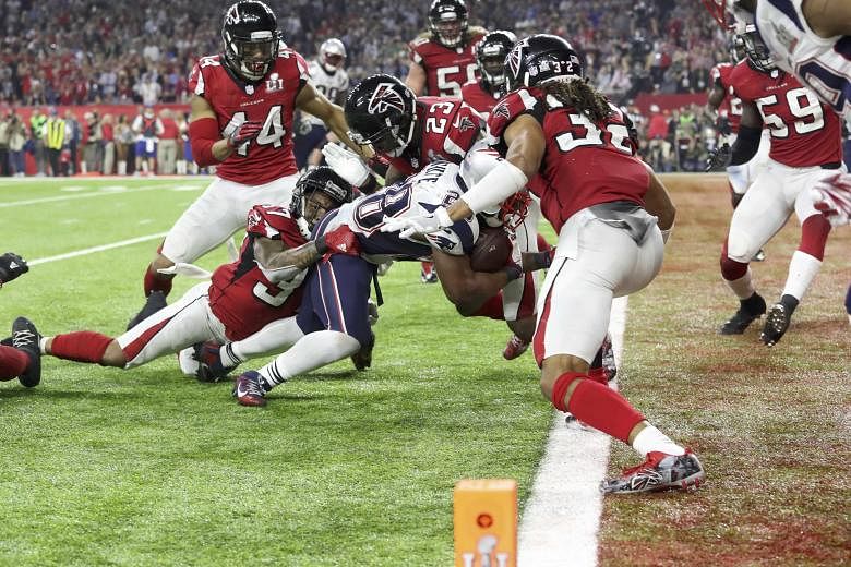 James White scoring a touchdown during overtime to win the New England Patriots their fifth Super Bowl. The Patriots trailed by 25 points before launching a late comeback to beat the Atlanta Falcons 34-28 at the NRG Stadium in Houston.