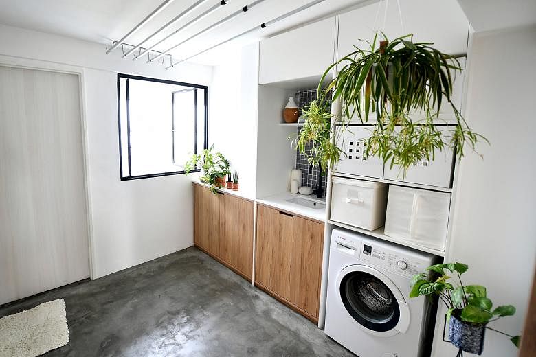 The wardrobe (left) serves as a partition wall between the living room and bedroom. In Mr Tan Hee Boon's three-room HDB flat (left), the marble kitchen counter doubles as a table for his desktop computer (above). A yard (below), which occupies the pr