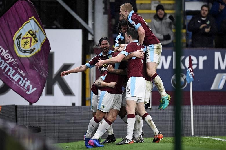 Welsh striker Sam Vokes (hidden) celebrating with Burnley team-mates after scoring against Leicester last month. It was the only goal of the match and took the Clarets' home league record this season to nine wins and a draw in 13 games.